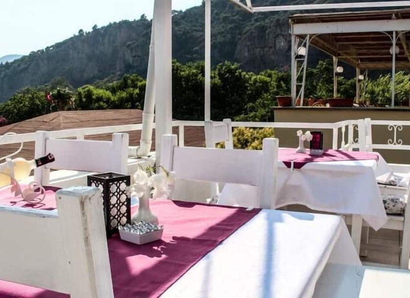 Dalyan Terrace Hotel terrace dining tables with mountain views in Dalyan, Mugla