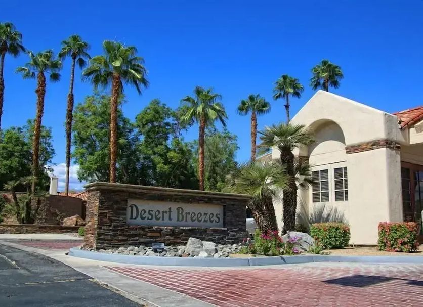 4 Seasons at Desert Breezes in Palm Desert with palm trees and resort entrance sign