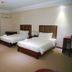 Big Hotel Suites Mandaue City guest room with two beds, sofa, desk, and air-conditioning