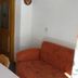 Pension Berggeist in Sölden, simple guest room with sofa, table, and wooden door