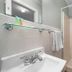 Echo Motel bathroom with sink, mirror, and shower in Old Orchard Beach