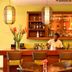 Pestana São Tomé bar with bartender, pendant lights and wicker seating in São Tomé