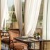 Danesfield House Hotel And Spa in Marlow dining room with wicker chairs and garden-view windows