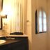 Hotel Maya del Mar Playa del Carmen bathroom with sink, mirror, shower curtain and checkered tile floor