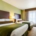 Cobblestone Hotel & Suites - Mccook guest room with two beds and window view in McCook