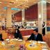 Jaypee Vasant Continental, New Delhi: elegant hotel restaurant with guests dining and open kitchen