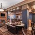 Hotel Bothwell Sedalia Central District lobby with fireplace, bar seating, leather chairs, and wood paneling.