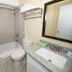Bathroom at Medicine Hat Suites in Medicine Hat with tub-shower, toilet, and granite vanity