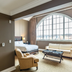 The Inn At Cobble Beach in Balmy Beach room with arched window, sofa, armchair and bed