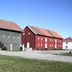 Airport Motel & Apartment in Gardermoen, exterior of rustic red and gray buildings under clear sky
