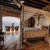 Quinta Maria Cortez Bed & Breakfast in Puerto Vallarta bedroom with ocean-view terrace and canopy bed
