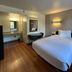 Studio 6 San Luis Obispo CA South guest room with single bed, desk, chair and vanity