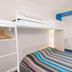 Hotelf1 Narbonne Sud in Narbonne guest room with bunk bed, double bed, desk and wall-mounted TV