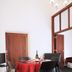 Bon Marie B&B Hamilton room with dining table, chairs, and bottle set near wooden doors