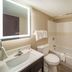 Baymont by Wyndham Laredo bathroom with vanity, toilet, shower-tub combo and white curtain