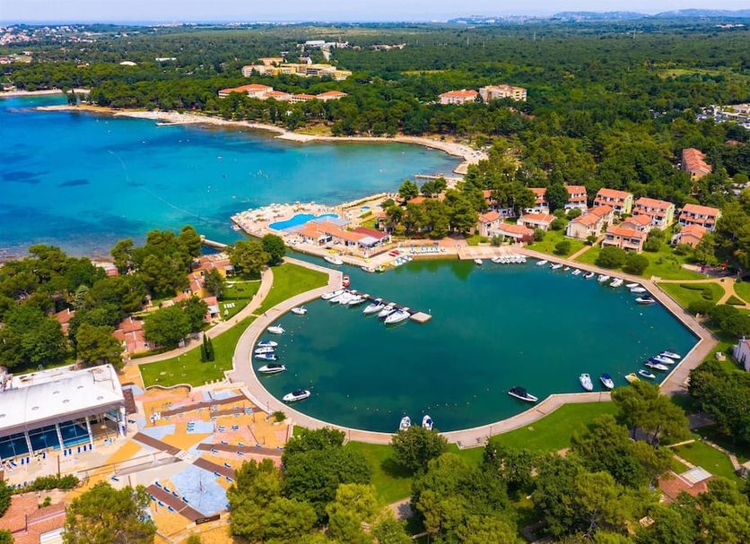 Apartments Stella Plava Laguna in Umag with a marina, boats, and a view of the turquoise bay