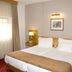 Hotel Rainha D. Amélia guest room in Castelo Branco with twin beds and window curtains