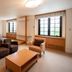 Colosseum Inn Tateshina guest room with twin beds, seating area, and large windows