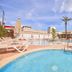 Ilusion Markus & Spa in Can Picafort: outdoor pool with loungers, umbrellas and palm trees