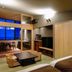 Houraiya Kamogawa guest room with tatami seating area, low table, TV, and ocean-view balcony