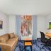 Fairfield Inn by Marriott Evansville East guest room with sofa, desk, chair, TV and blue patterned carpet