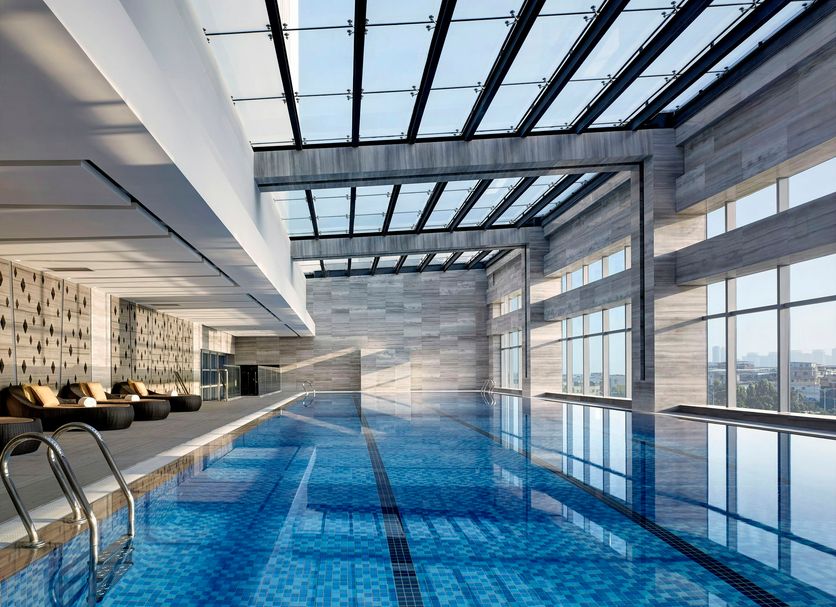 Langham Place, Xiamen indoor infinity pool with floor-to-ceiling windows and city views