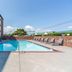 Comfort Inn Aikens Center in Martinsburg outdoor pool with lounge chairs and brick hotel exterior