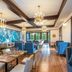 Naramata Inn dining room with chandeliers, blue seating, and large windows