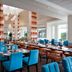 Hilton Garden Inn Montreal Airport dining room with blue chairs and large windows