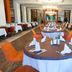 Seher Sun Palace Resort & Spa in Side, elegant hotel restaurant with set tables and orange chairs