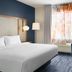 Fairfield Inn & Suites by Marriott Sacramento Airport Natomas guest room with king bed, desk and window view