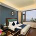 Hotel Woodrina in Shimla guest room with double bed, window view and seating area