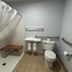 Jacksonville Inn & Suites bathroom with roll-in shower, grab bars, and toilet in Jacksonville