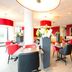 Bastion Hotel Dordrecht Papendrecht restaurant with red chairs and tables in Dordrecht