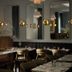 Hotel Belvedere in Kingston dining room with set tables, wall sconces, mirrors, and floral arrangements