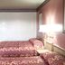 OYO Hotel Kings At Clovis guest room with two beds, wall lamp, and open closet niche