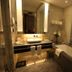 Vip Hotel Doha bathroom with double vanity, lit mirror, soaking tub and glass shower