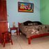 Arte Natura Boutique Hotel in La Fortuna guest room with bed, stool, and wall art