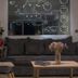 Belvedere Village in Agia Pelagia lobby with dark sofa, chairs, coffee table and wall map artwork