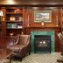 Residence Inn by Marriott West Orange library lounge with fireplace, leather chairs and built-in bookshelves