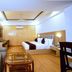 Grand Legacy Beacon, Dehradun guest room with king bed, sofa seating, desk and wooden floor