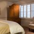 Wine Country Inn in Jacksonville guest room with bed, armoire, framed art, and window shutters