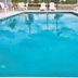 Holiday Inn Express & Suites Brooksville West pool with lounge chairs in Brooksville