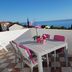 Apartments Antonio in Cavtat terrace with table, pink chairs and sea view