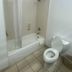 Truckerz Inn Jacksonville bathroom with bathtub, shower curtain, and toilet