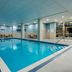 Indoor pool at Residence Inn by Marriott Kingston Water's Edge in Kingston with lounge chairs and handrails