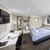 Countryman Motor Inn in Dubbo: twin-bed guest room with TV, desk, and ensuite bathroom doorway