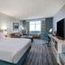 Hilton Garden Inn Jacksonville Ponte Vedra Sawgrass guest room with king bed, sofa and TV in Ponte Vedra Beach