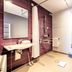 Premier Inn Lübeck City Stadtgraben bathroom with shower, sink, toilet and purple tile accent wall