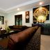 Palm Grove Resort Pattaya living room with sectional sofa, coffee table, TV, and decorative wall art